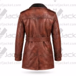 Rear view of a distressed brown leather winter trench coat featuring shoulder epaulets, structural back seams, and a belt.
