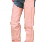 A person models Pink Leather Womens Chaps over blue denim shorts with black boots, highlighting a bare midriff and visible tattoos at the waistband.