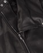 Close-up of textured leather grain on Marlon biker jacket with polished hardware