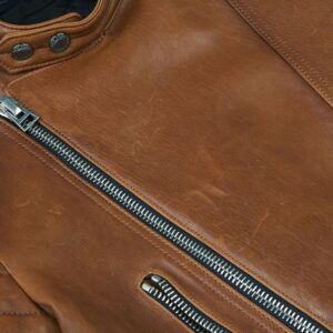 Close-up of grainy leather texture on Scott brown biker jacket