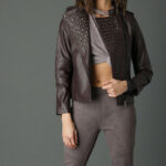 Brown leather moto jacket for women featuring silver studs and classic biker style.