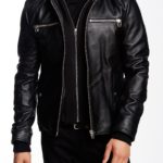 Men’s black biker leather jacket with detachable fabric hood and zip closure.