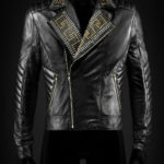 Man wearing black leather biker jacket with golden and silver studs across chest and shoulders