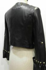 Detail shot of spiked and studded shoulders on black biker leather jacket for women