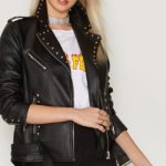 Woman wearing biker-style magnificent leather jacket with silver stud embellishments