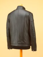 Men’s black leather jacket with zipper accents and raised collar displayed against neutral background.