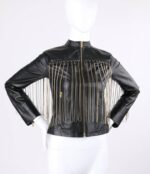 A black leather jacket with gold chain fringe on a mannequin. The jacket features a front zipper and standing collar, exuding a bold, edgy style.