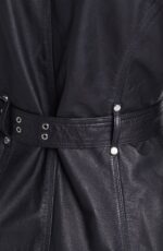 Black leather motorcycle jacket for women featuring a belted waist and asymmetrical zip for classic biker style.