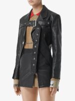 Black leather motorcycle jacket for women with a belted waist, notched lapel, and modern biker vibe.