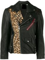 A stylish black leather jacket with leopard print panel on the left front, studded right shoulder, and red zipper pocket, conveying a bold, edgy vibe.