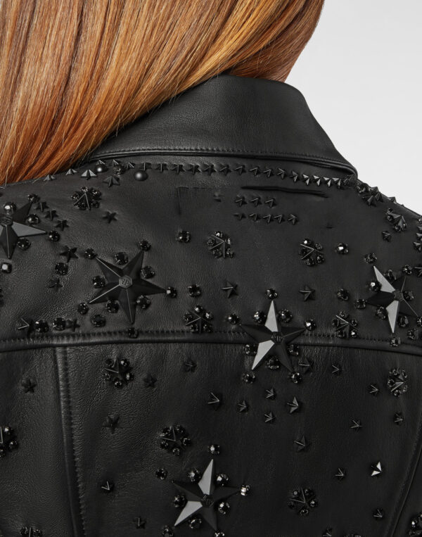 Edgy black leather jacket with quilted panels, metallic star embellishments, beads, and a stylish belt for standout fashion.