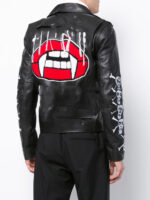 Black leather biker jacket with silver zippers and buttons, featuring white skull and crossbones on sleeves for a rebellious edge.