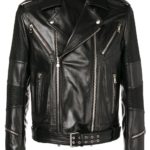 A black leather biker jacket with multiple zippers and metal studs. It features a classic cut with a belted waist, creating a bold, edgy look.