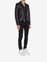 Black leather motorcycle jacket featuring an asymmetrical front, metallic hardware, and bold skull print inner lining.