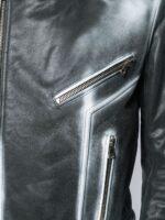 Edgy black-to-silver gradient leather jacket with asymmetrical zip closure and sharp collar, styled with sleek black pants.