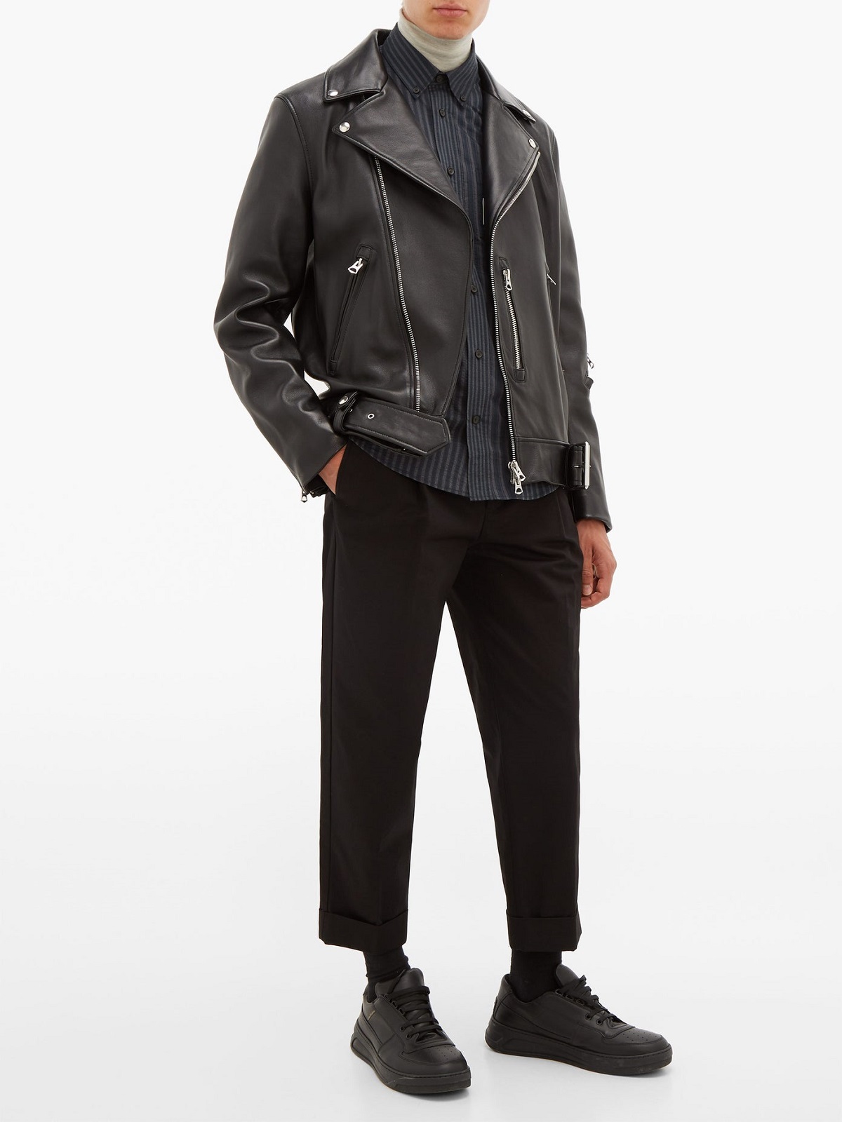 A person wearing a black leather jacket, dark pants, and black shoes, exuding a stylish and edgy vibe. The outfit blends casual and chic elements. A person wearing a black leather jacket, dark pants, and black shoes, exuding a stylish and edgy vibe. The outfit blends casual and chic elements.