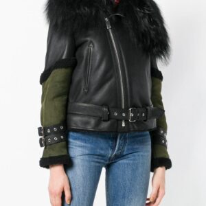 Edgy black leather jacket featuring a plush fur collar, asymmetrical front zip, and contrasting green sleeves with belted accents.