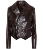Dark brown leather jacket featuring wide lapels, double-breasted silver buttons, and zippered pockets. The jacket exudes a bold, stylish vibe.