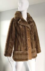 Elegant faux fur winter coat in light brown, featuring plush texture, oversized lapels, and statement buttons.