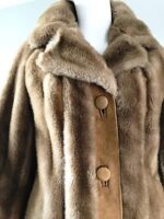 Chic light brown faux fur coat with soft, warm texture and wide lapel design, perfect for stylish cold-weather wear.