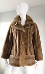 Plush light brown winter coat with faux fur finish, large buttons, and a classic lapel collar for a timeless look.