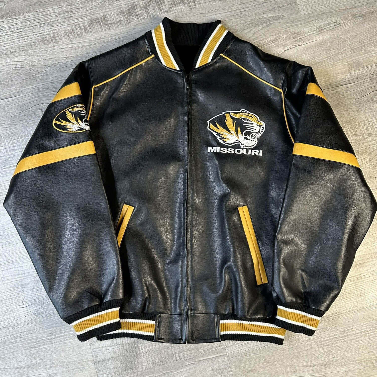 Vintage-University-of-Missouri-Tigers-Leather-Jacket-1 front view of missouri tigers leather jacket featuring rib knit collar cuffs and embroidery logos on chest and arm.