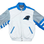 The NFL Carolina Panthers Jeff Hamilton Full Leather Jacket is white with blue and silver accents, a black panther head logo on the chest, blue-striped sleeves, blue-trimmed pockets, and a blue collar in varsity style.
