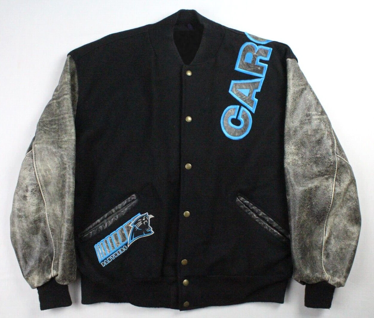 Vintage-NFL-Carolina-Panthers-Varsity-Jacket-1 The Vintage NFL Carolina Panthers Varsity Jacket features distressed gray leather sleeves, bold blue CAR on the chest, a Panthers logo patch with Carolina on the lower left, gold snap buttons, and a black collar.