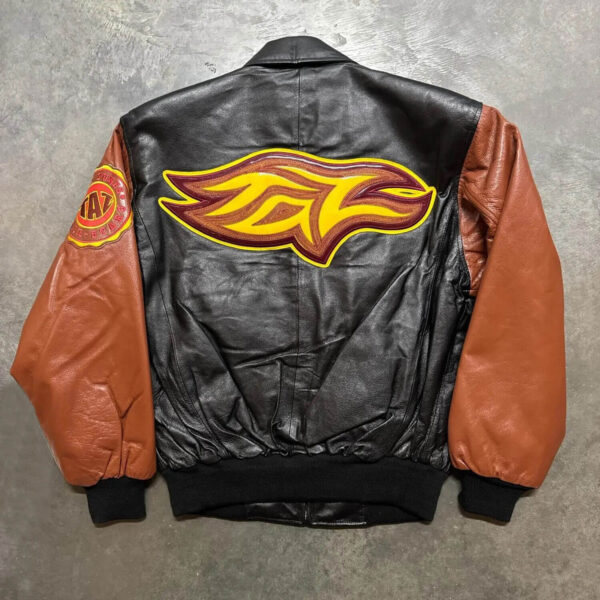A Tasmanian Devil leather jacket with a large yellow and red flame logo on the back and a circular patch on the left sleeve.