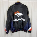 Vintage Denver Broncos leather bomber jacket color-blocked sleeves in navy, white, and orange, and rib-knit collar, cuffs, and waistband.