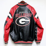 Back of vintage NCAA Georgia Bulldogs bomber leather jacket with large team logo, "Georgia Bulldogs" text, and bold red and black color-block design.