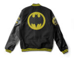 "Back view of Batman Super Heroes black varsity jacket featuring large yellow Batman logo and leather sleeves"