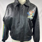 "Front view of Vintage Disney Winnie The Pooh Acre Tigger black leather jacket with Tigger face patch and fast on his paws text on chest, rib-knit cuffs, and snap button collar"