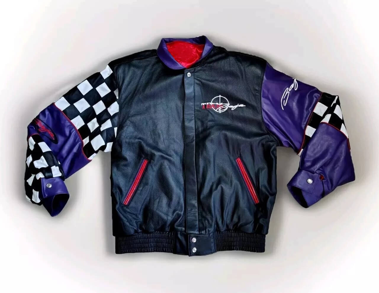 Vintage-Jeff-Hamilton-Team-Baja-Leather-Bomber-Jacket-1 Front View Of Team Baja leather jacket with stand-up collar, snap closure, and TEAM Baja logo on chest.