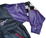 Close-up of left sleeve on Vintage Jeff Hamilton Team Baja leather bomber jacket showing Baja spell embroidery.