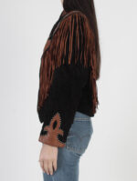 Vintage Diamond Leathers Western fringed suede jacket in black and brown, side view showing fringe details on shoulders and brown leather fleur-de-lis design on sleeve.