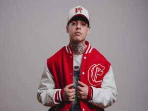 Person wearing a red and white varsity jacket and cap.