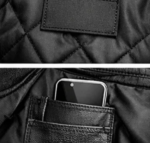 Leather vest inner pocket holding smartphone close-up