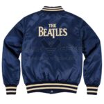 Back View of The Beatles Blue Satin Jacket featuring bold THE BEATLES lettering on the back.