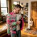 Man trying on graphic varsity jacket at home