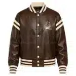 Front View Of Cleveland Browns Brown Leather Jacket Featuring cartoon logo, cream details, and snap-button closure.