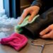 Hands drying a leather jacket cuff after snow
