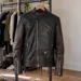 Black and brown biker jacket in an apartment