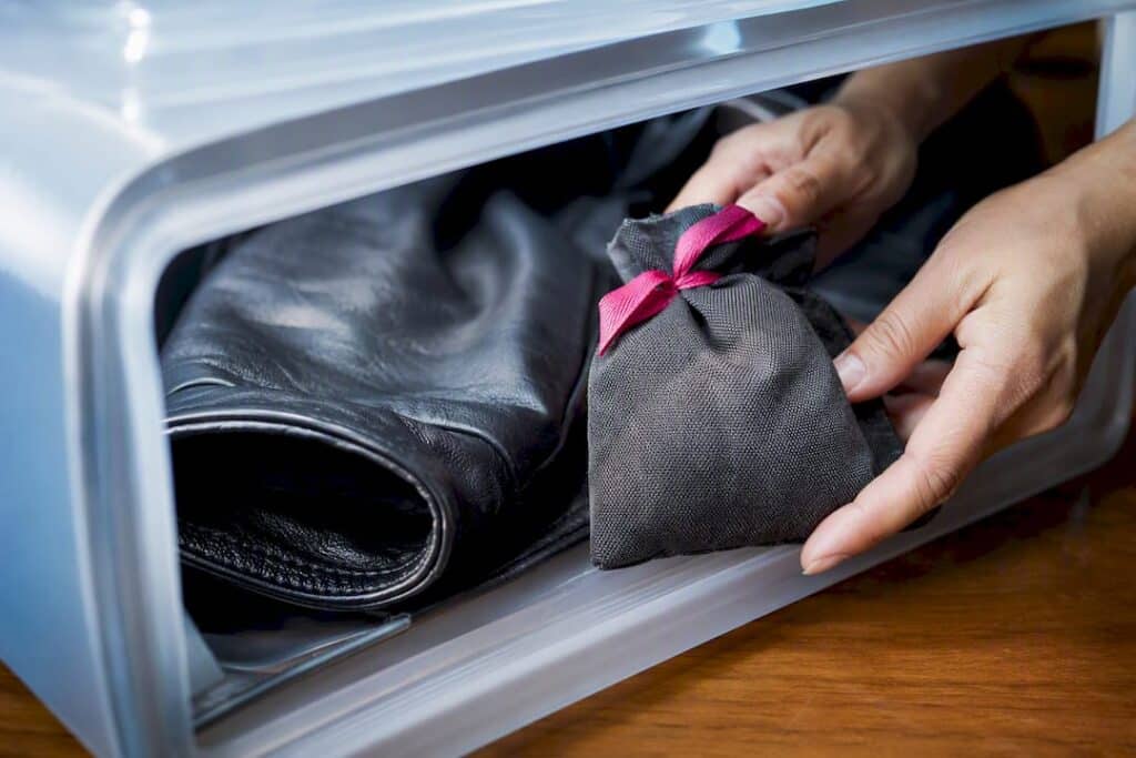 Charcoal sachet beside leather garment lining